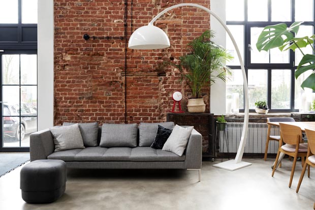 Living room interior in loft apartment in industrial style with
