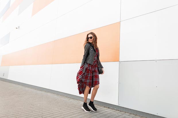 Cool positive young girl in red youth checkered dress in vintage