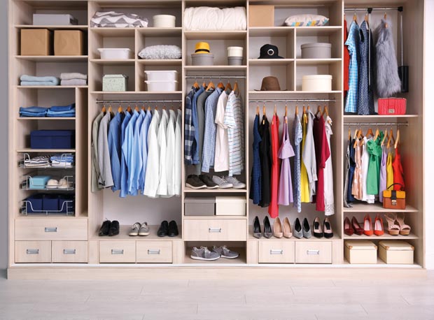Big wardrobe with different clothes for dressing room