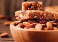 Cereal bar with almond and berry on thw wooden table
