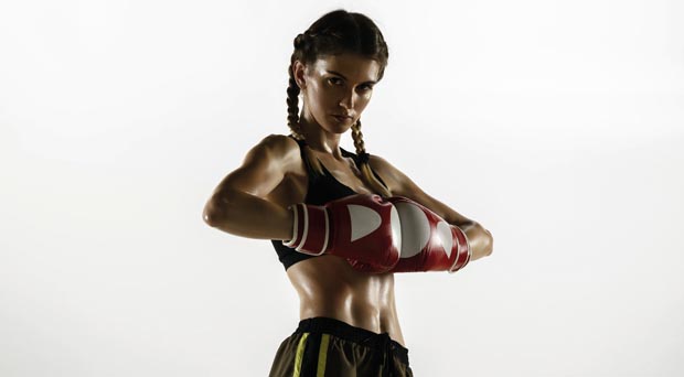 Fit caucasian woman in sportswear boxing isolated on white studio background