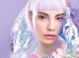 Cool sensual young blond girl with ideal brows, purple hair and perfect makeup, healthy glowing skin in colourful iridescent foil