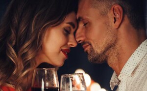 Young lady kiss her gorgeous man while have romantic dinner