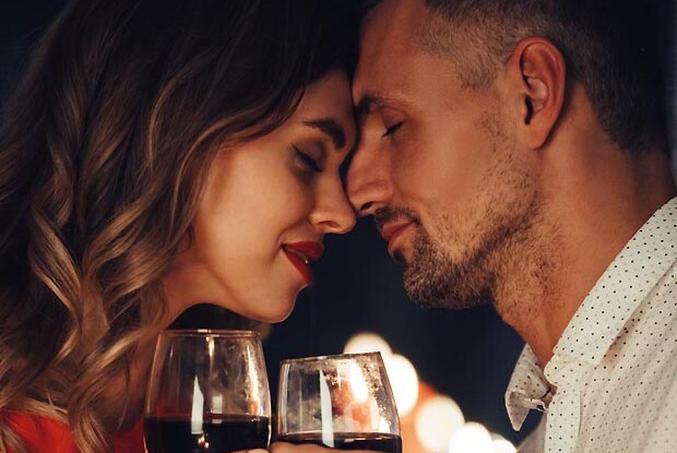Young lady kiss her gorgeous man while have romantic dinner